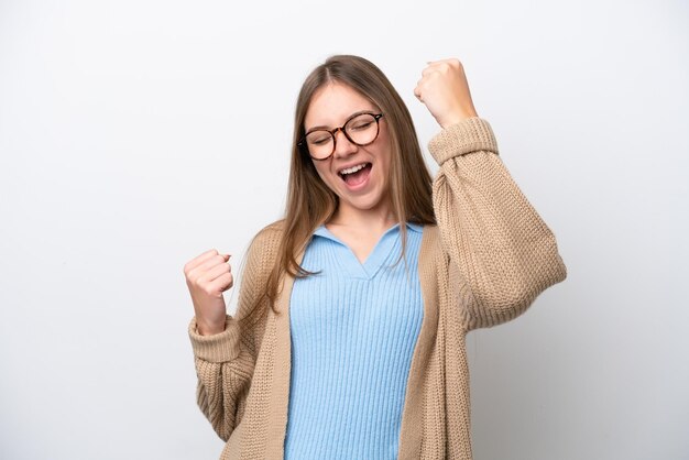 Young Lithuanian woman isolated on white background celebrating a victory