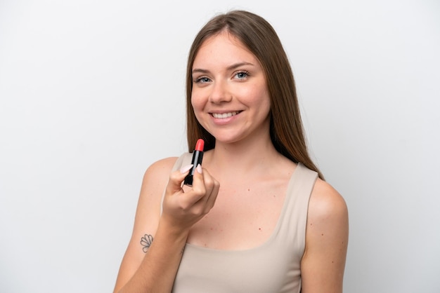 Young Lithuanian woman isolated on white background holding red lipstick