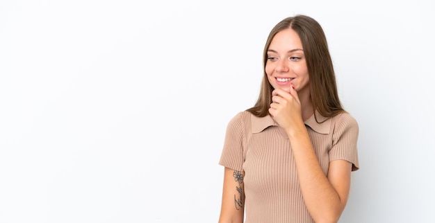 Young Lithuanian woman isolated on white background looking to the side and smiling