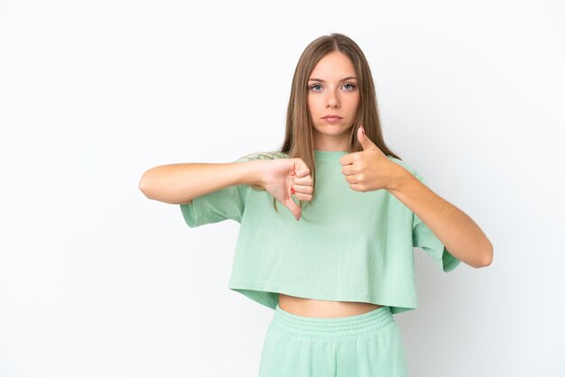 Photo young lithuanian woman isolated on white background making good-bad sign. undecided between yes or not