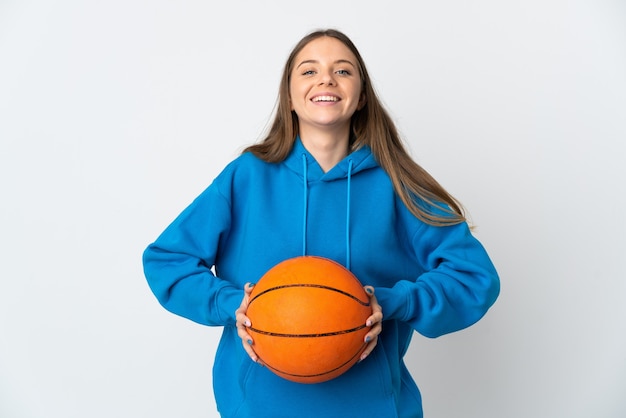 Young Lithuanian woman isolated on white background playing basketball