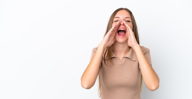 Young Lithuanian woman isolated on white background shouting and announcing something