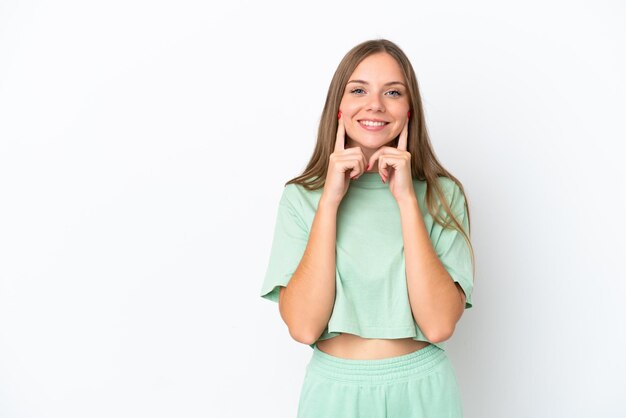 Young Lithuanian woman isolated on white background smiling with a happy and pleasant expression