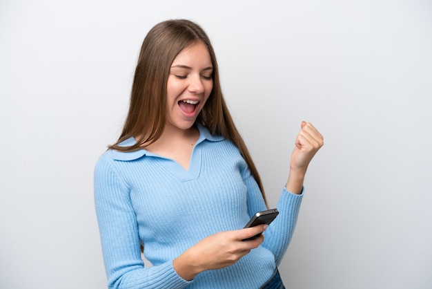 Young Lithuanian woman isolated on white background with phone in victory position