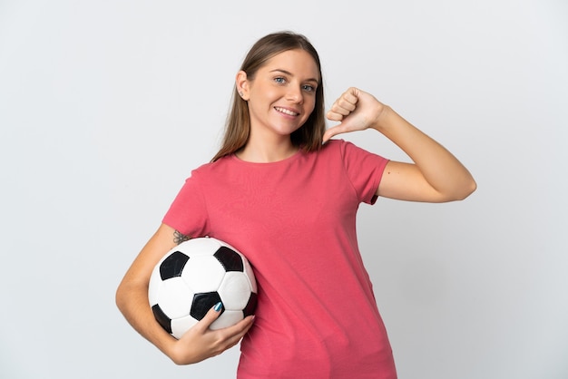 Young Lithuanian woman isolated on white background with soccer ball and proud of himself