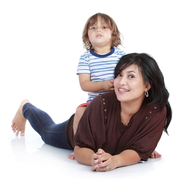 young little son and his pretty young mother in isolated over white