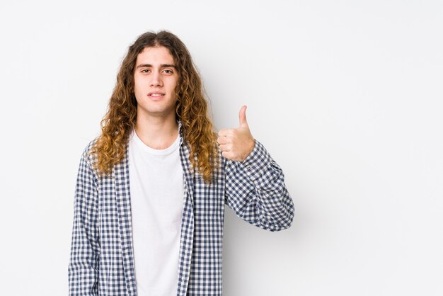 Young long hair man posing isolated smiling and raising thumb up
