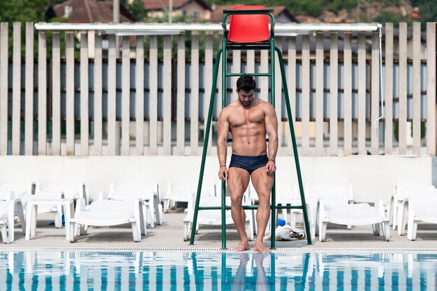 Young Looking Lifeguard Man At Swimming Outdoor Pool