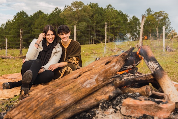 Young loved couple of tourists have a date in the forest