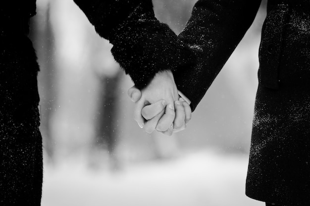 Young loved couple on winter snowy day