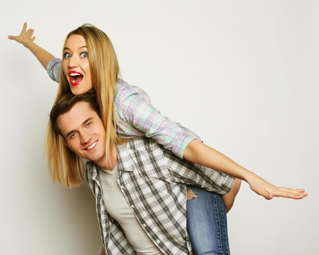 Young lovely couple posing in studio close up happy man and happy woman