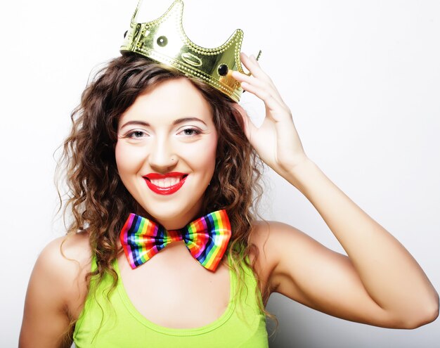 Young lovely expression woman in crown over white\
background