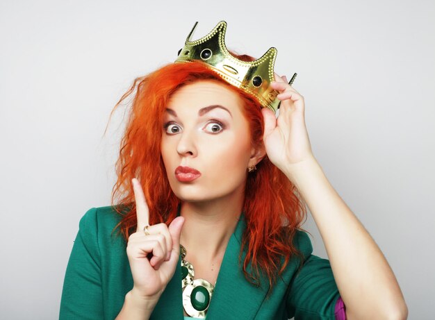 Young lovely redhair woman in crown