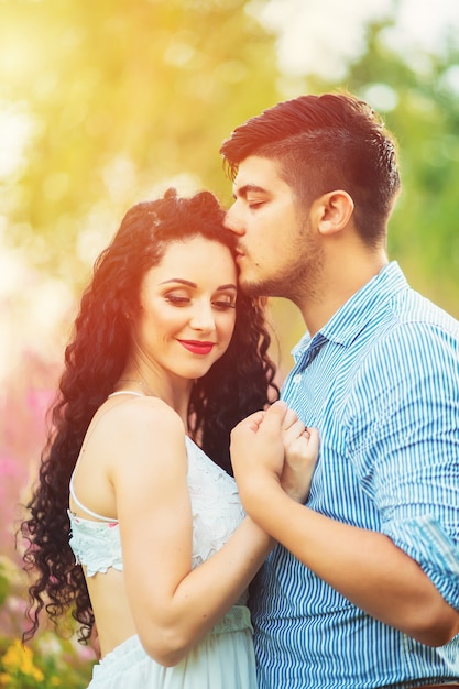 Young loving couple in a flower field