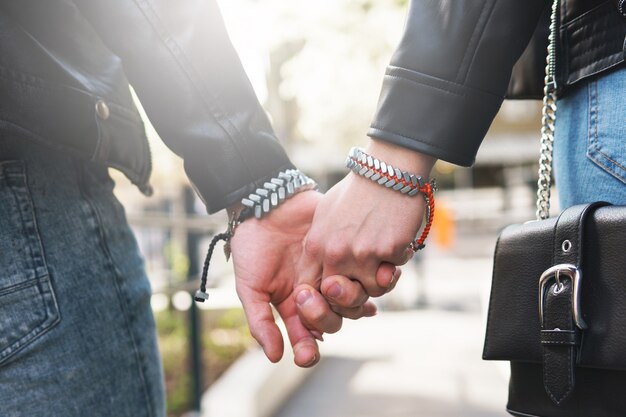 Young loving couple holding hands during a date outdoors