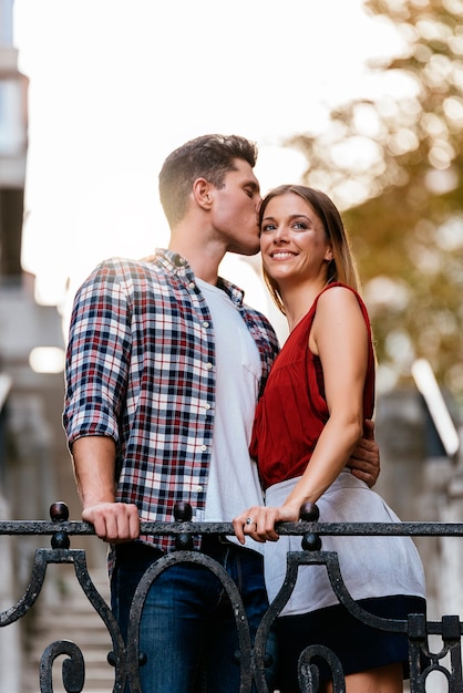 Young loving couple kissing in the street. Young Love Concept.