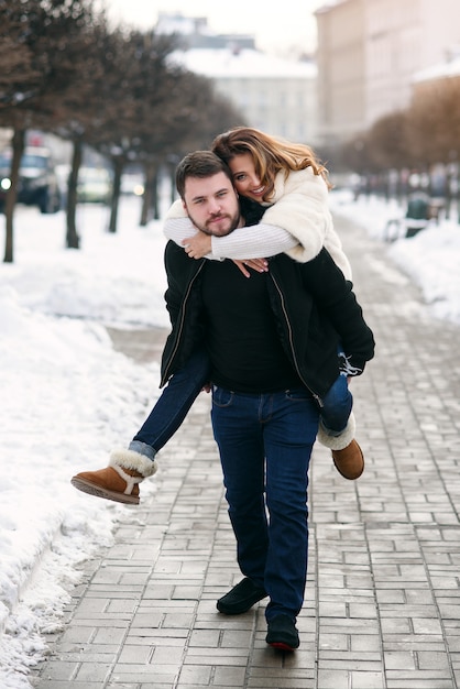 Young loving couple on natural winter . New Year and Christmas.