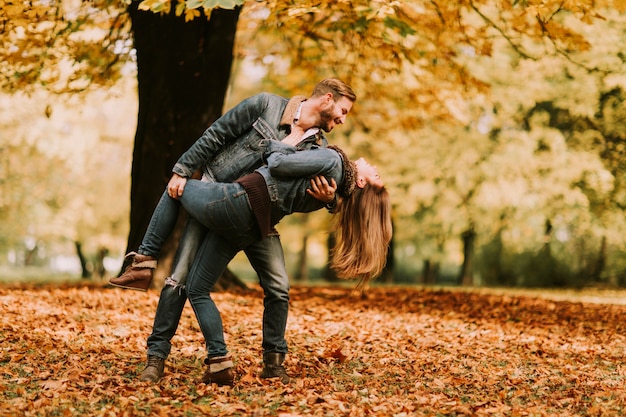 Young loving couple in the park on a sunny autumn day