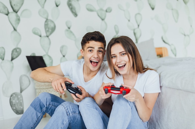 Young loving couple playing video games