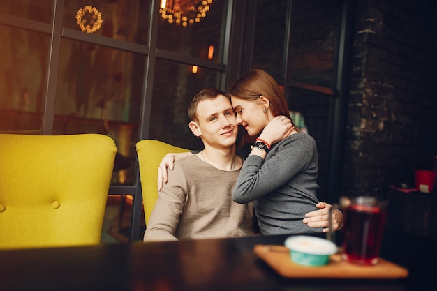 Young and loving couple sitting in a cafe