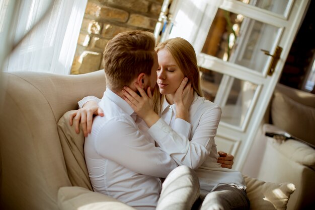 Young loving couple on the sofa