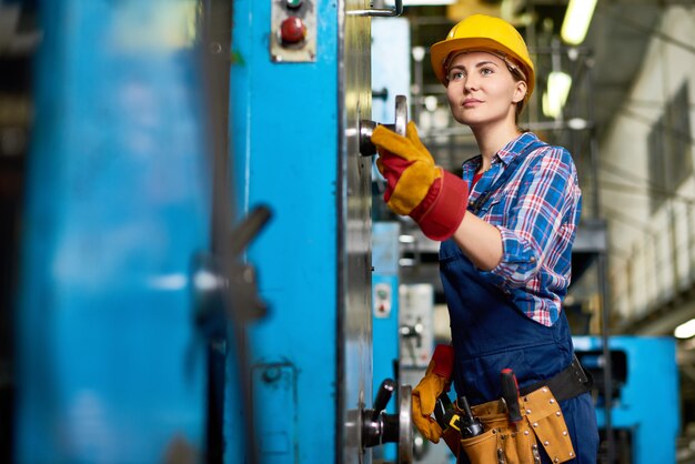 Young Machine Operator Concentrated on Work