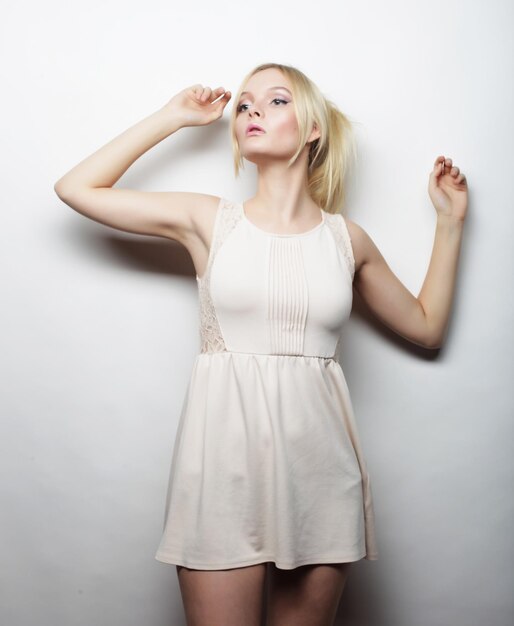 Young magnificent woman in white dress