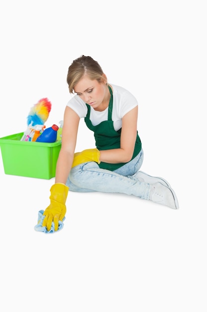 Young maid cleaning floor