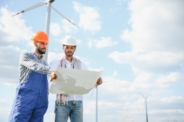 Young maintenance engineer team working in wind turbine farm