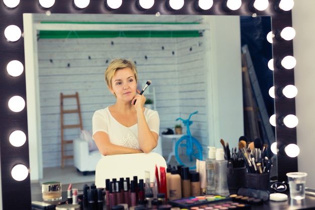 Young make-up artist with brushes