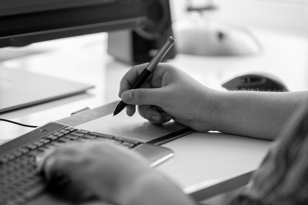 Young male adult is woking at his desk