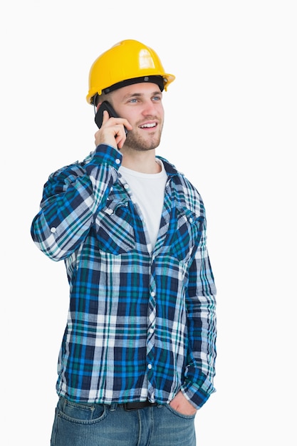 Young male architect using cellphone