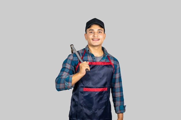 Young Male Asian Farmer with Agricultural Tools wearing an apron in Nepal