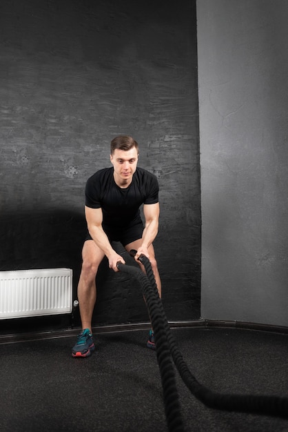 Young male athlete in the gym during training with two ropes Preparing an athlete for competition