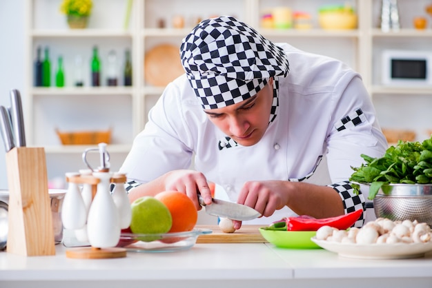 Young male cook working in the kitchen