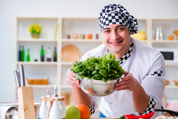 Young male cook working in the kitchen