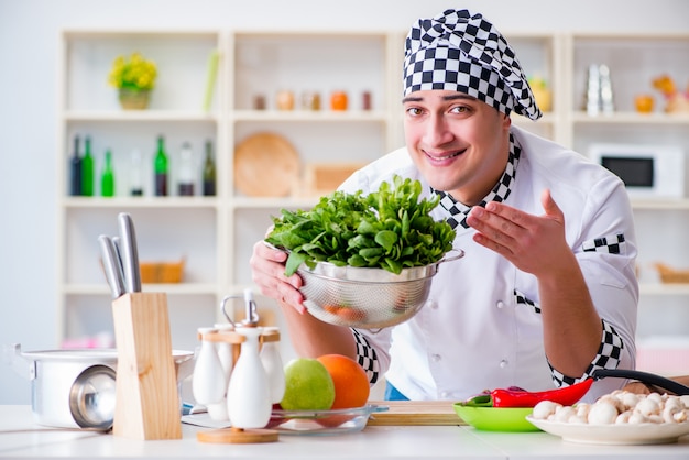 Young male cook working in the kitchen