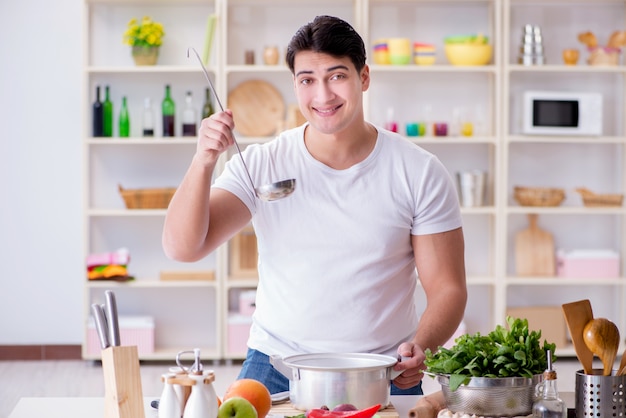 Young male cook working in the kitchen