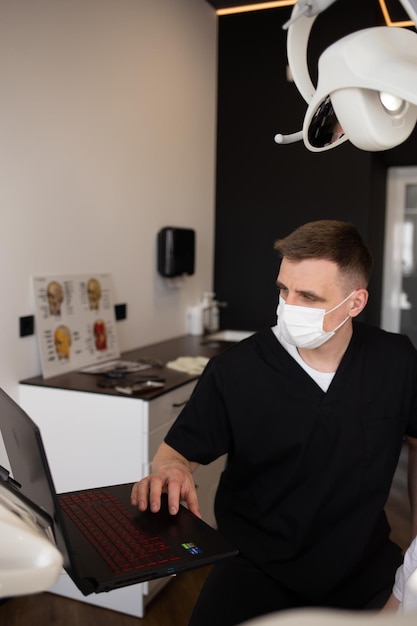 Young male dentist working in the clinic