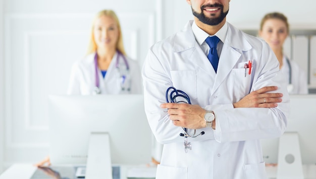 Young male doctor in front of medical group