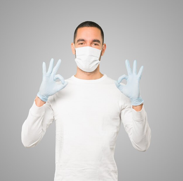 Young male doctor wearing mask and protective gloves