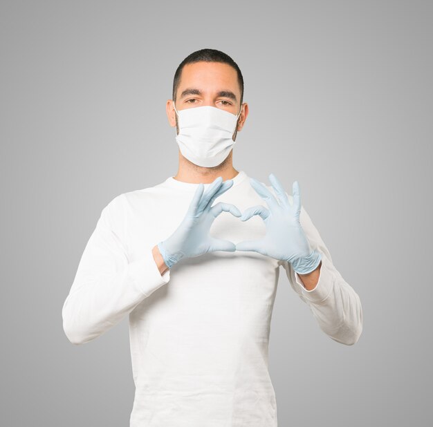 Young male doctor wearing mask and protective gloves