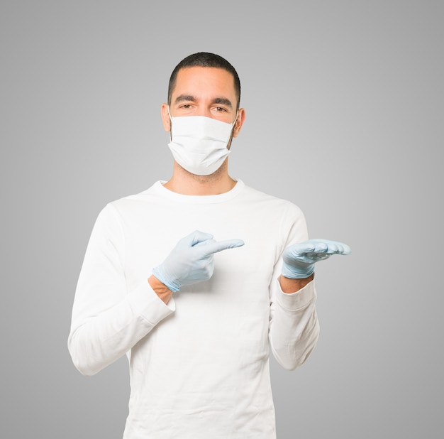 Young male doctor wearing mask and protective gloves