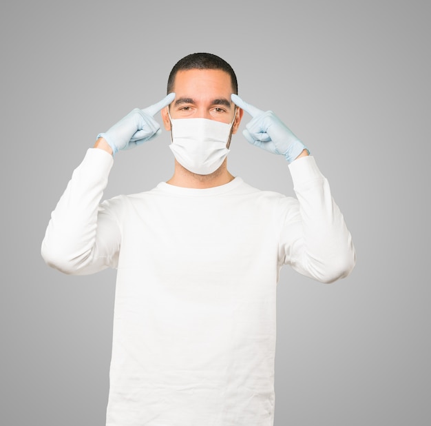 Young male doctor wearing mask and protective gloves