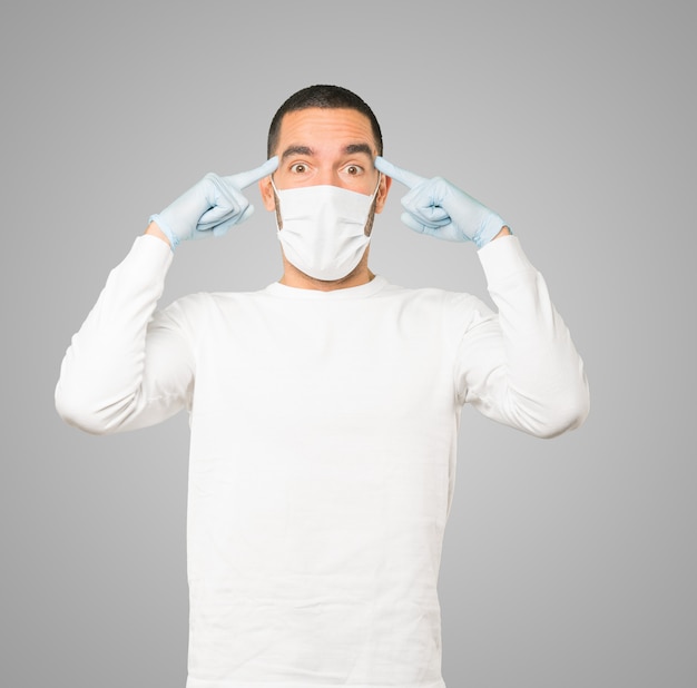 Young male doctor wearing mask and protective gloves