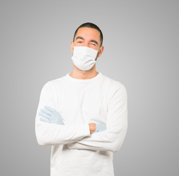 Young male doctor wearing mask and protective gloves