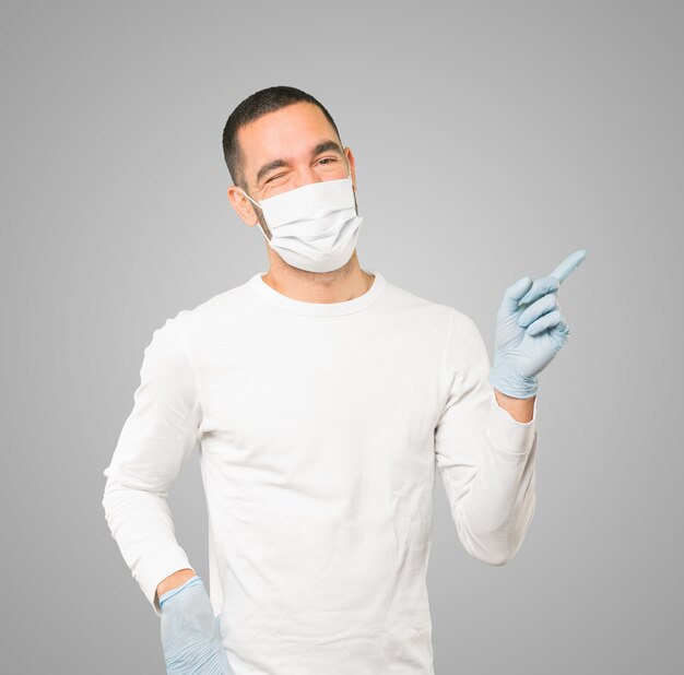 Young male doctor wearing mask and protective gloves