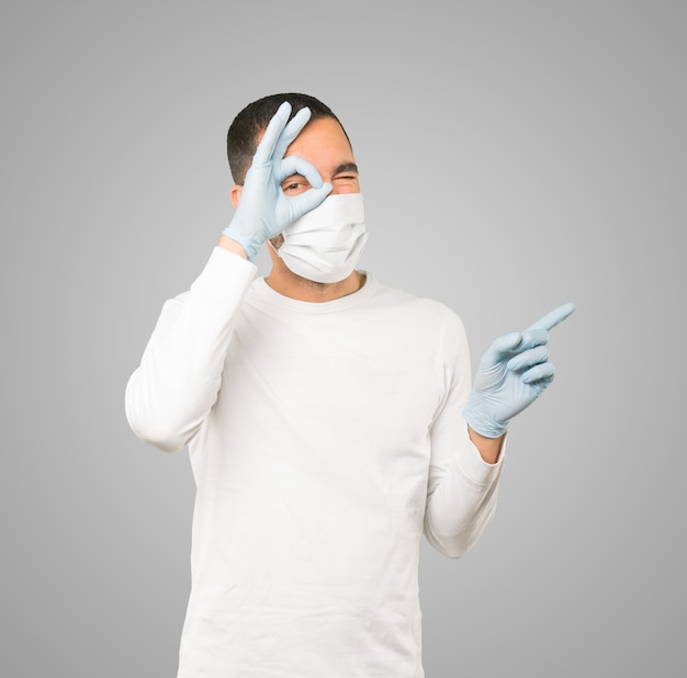 Young male doctor wearing mask and protective gloves