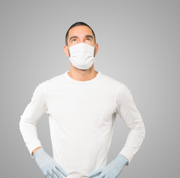 Young male doctor wearing mask and protective gloves