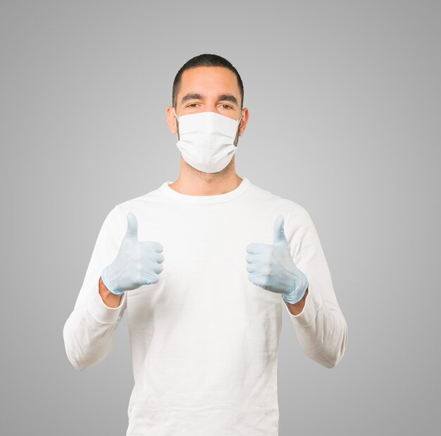 Young male doctor wearing mask and protective gloves